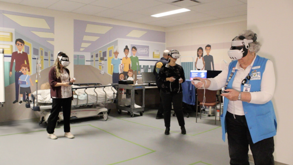 Three healthcare workers wearing VR headsets participate in a virtual stroke training simulation at Royal Victoria Regional Health Centre using Lumeto’s InvolveXR.
